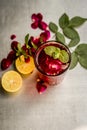 Popular Indian/Asian sharbat i.e GULAB KA SHARBAT with sliced lemon,Citrus Ãâ limon,Rosa,rose petals and mint leaves on a silver